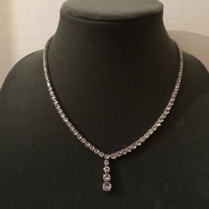 Silver diamond tennis necklace with infinity diamonds.